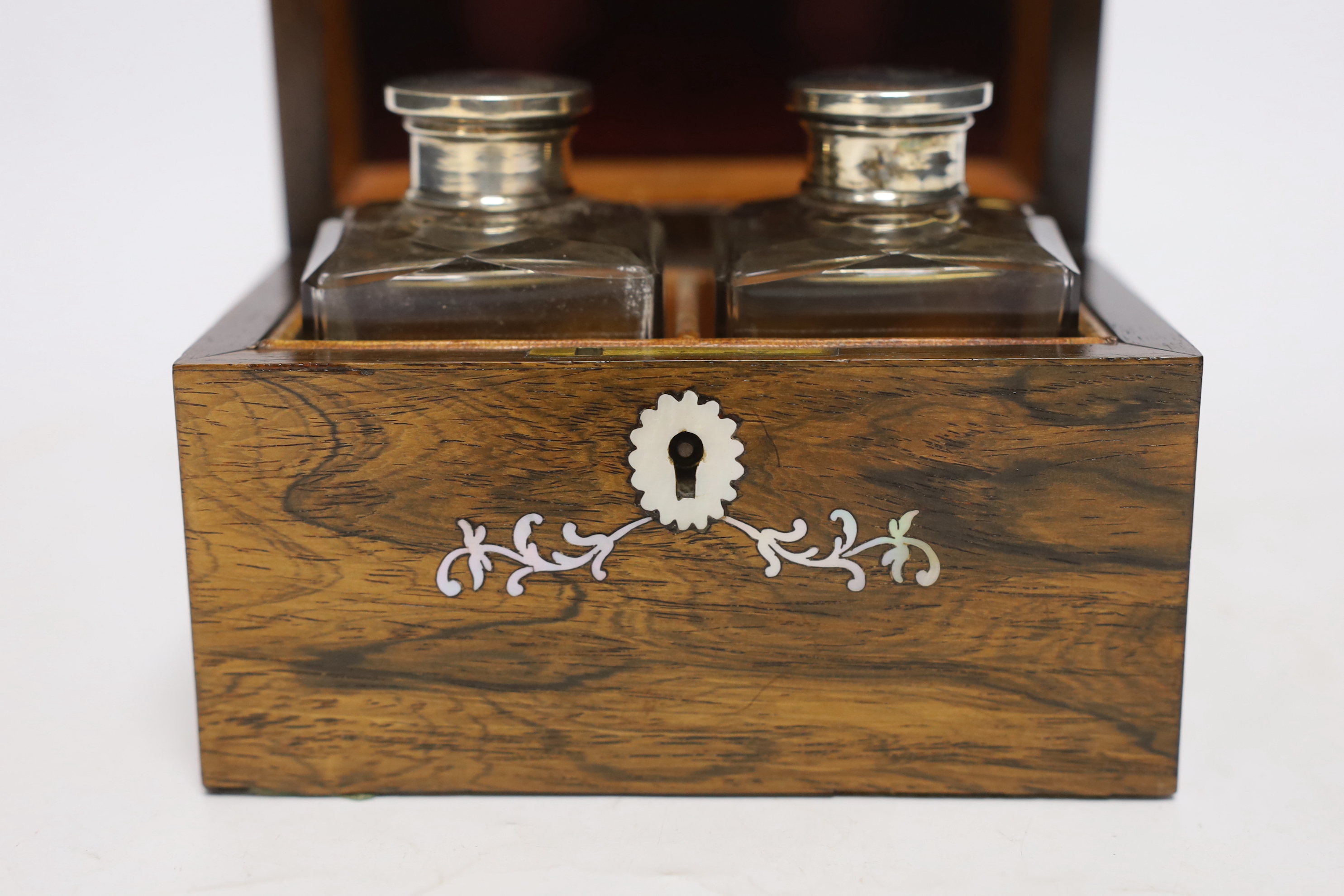 A 19th century mother-of-pearl inlaid rosewood travelling toilet box with two white metal mounted bottles, 14cm wide